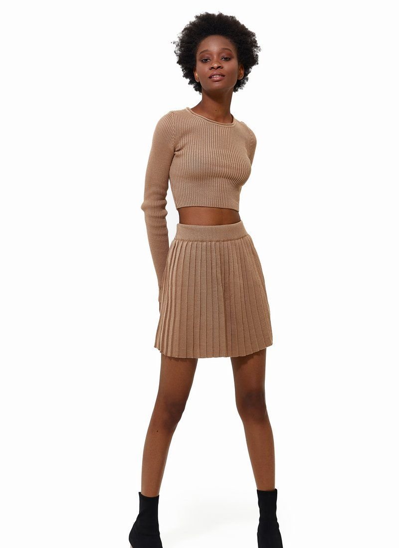 Beige knitted suit with short skirt