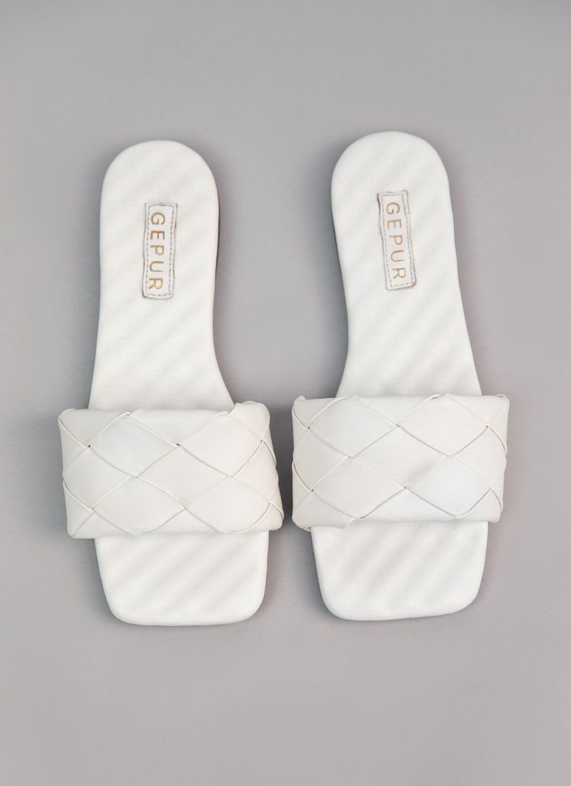 White flat-soled flip-flops made of genuine leather